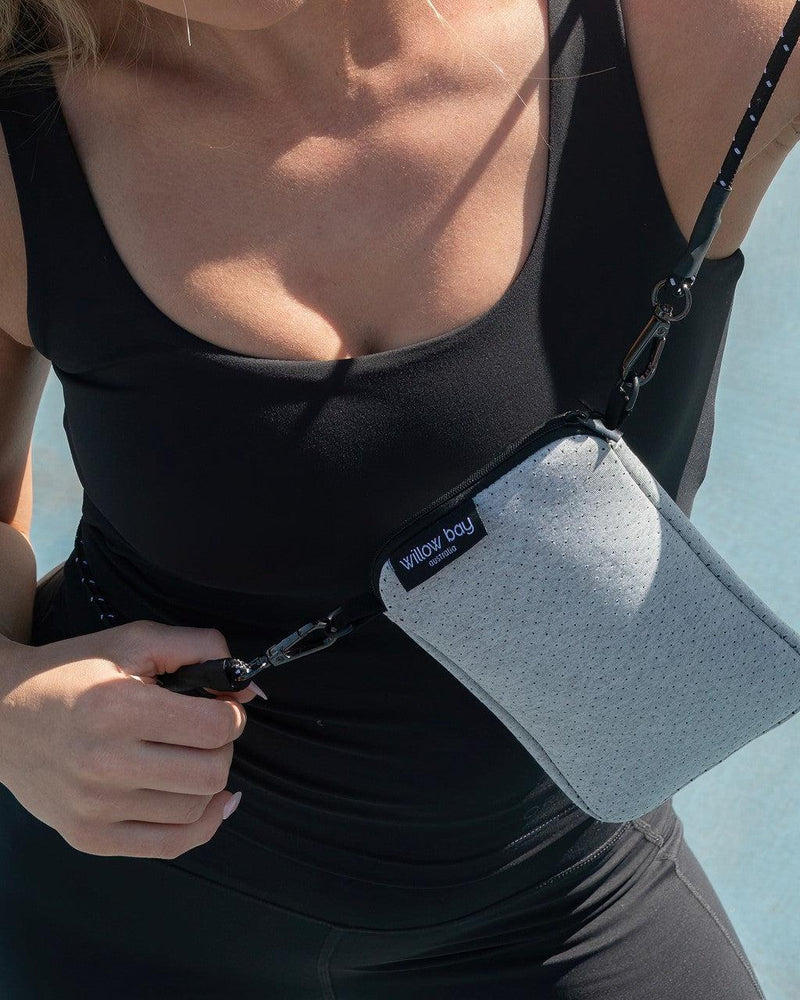 Willow Bay Light Marle neoprene phone crossbody bag with black rope strap on a woman.