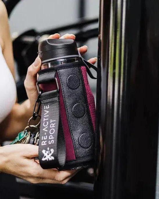 Burgundy Magnetic Gym Caddy holding a water bottle, with a "Re-Active Sport" strap.