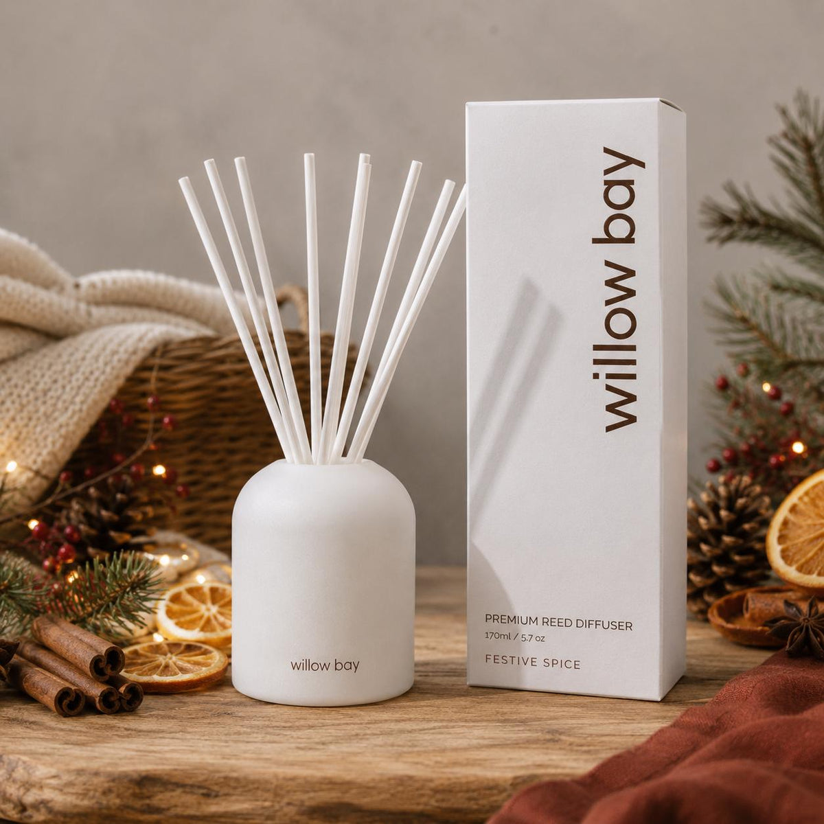 White Willow Bay Premium Reed Diffuser (Festive Spice, 170ml) with reeds and matching box, surrounded by holiday decor.
